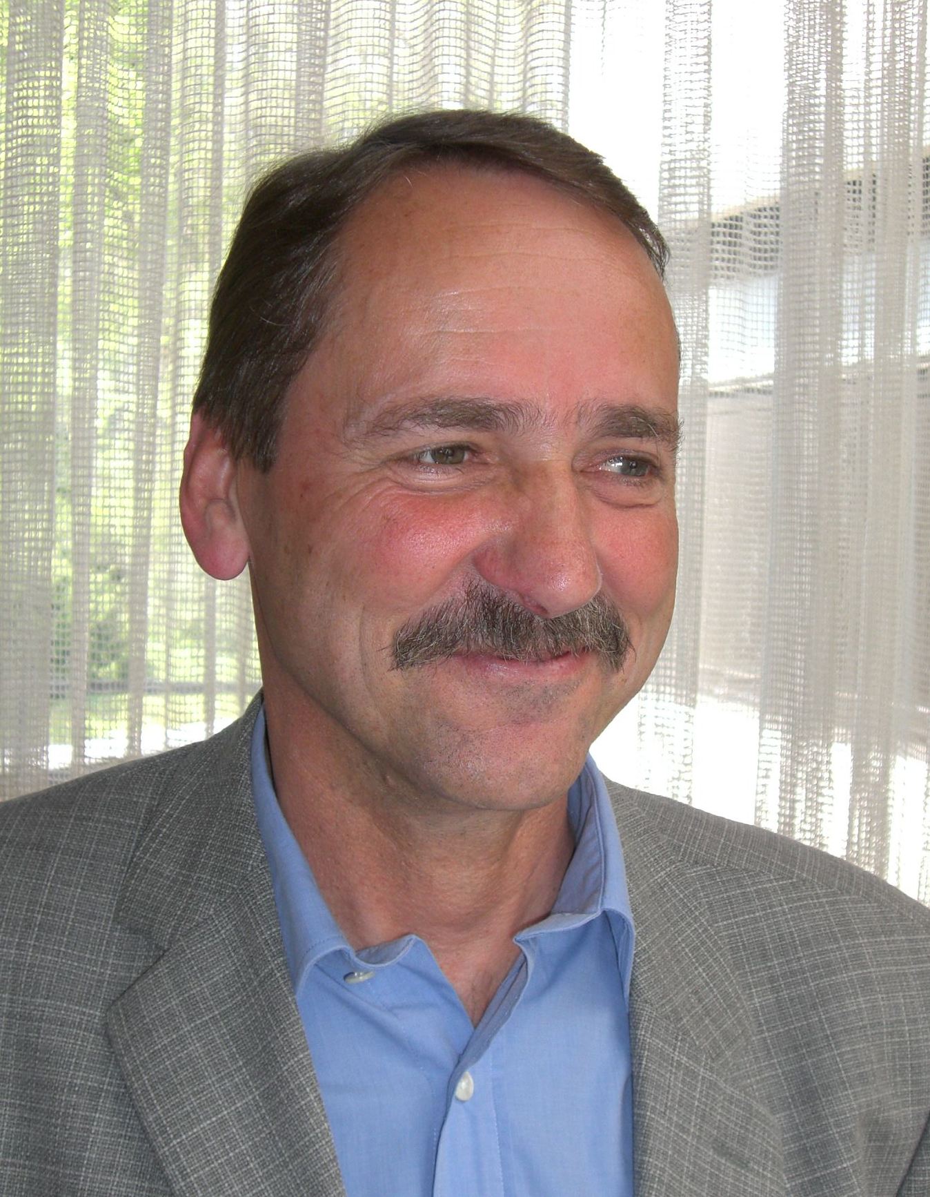 Portraitbild von Dr. Kunibert Battige